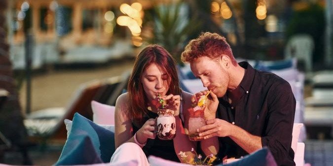 Happy young couple is together on their vacation outdoors at sunny daytime