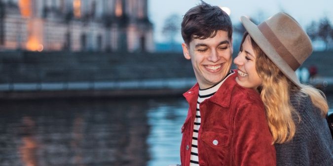 Smiling couple embracing at lake